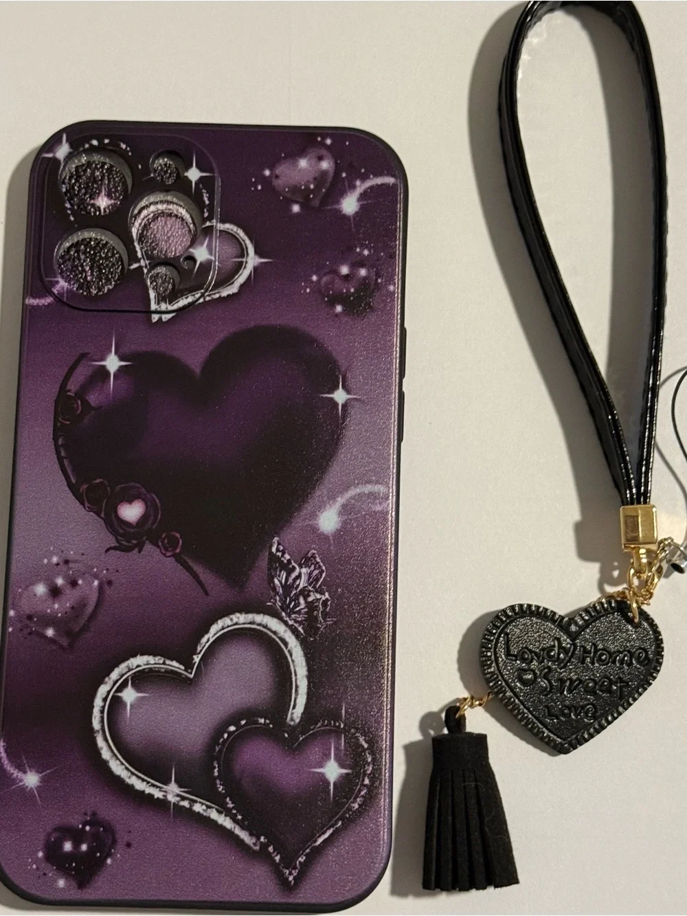 Purple Heart Pattern Phone Case with Wrist Strap for Apple 16 pro max.
